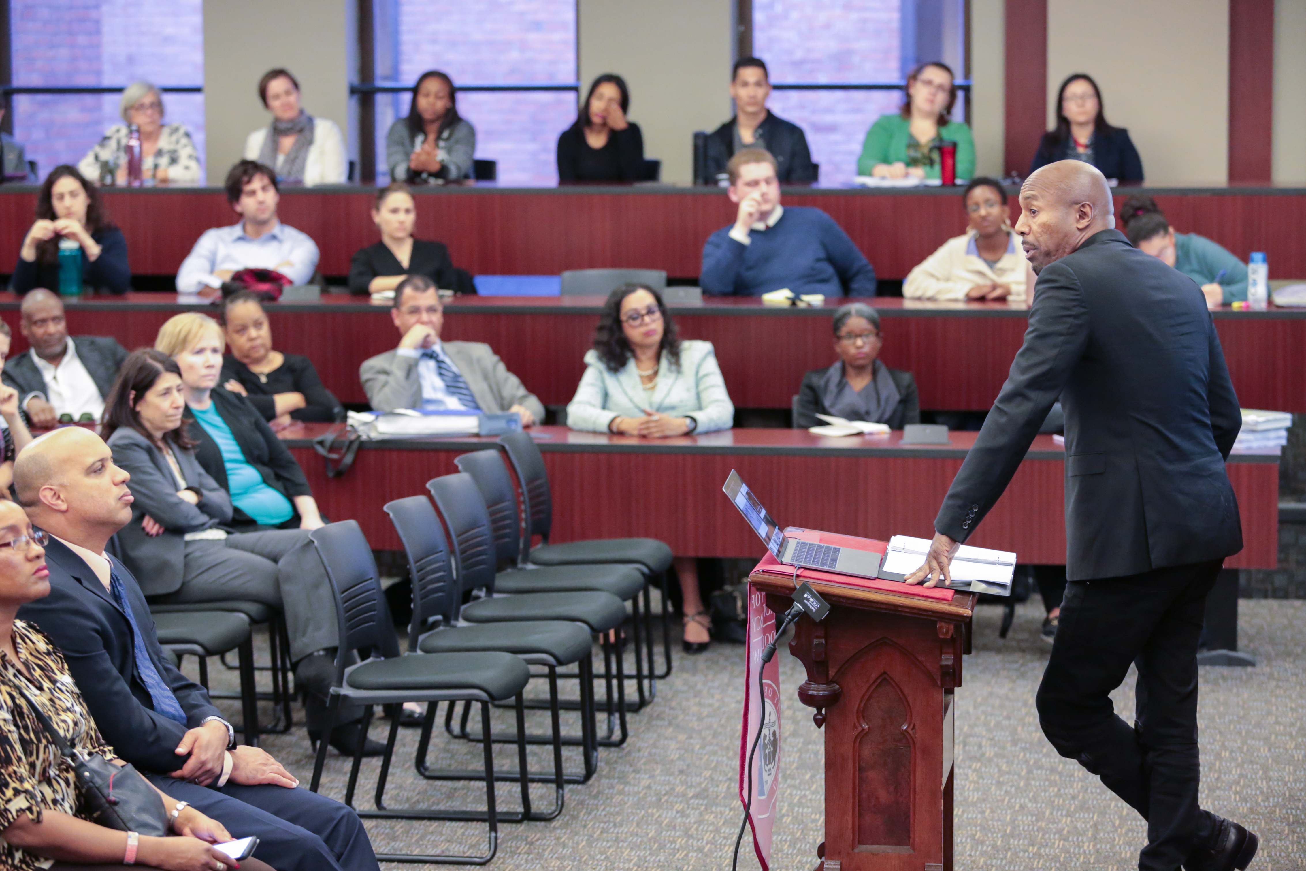 Paul Butler, right, addresses an audience of Detroit leaders, students and members of the area's law community.