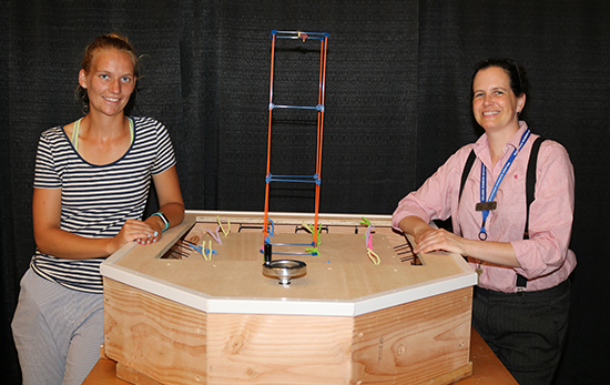 Detroit Mercy student Nynke Van Der Goot, left, and Cassie Byrd, chief learning officer at the Michigan Science Center, with the table.