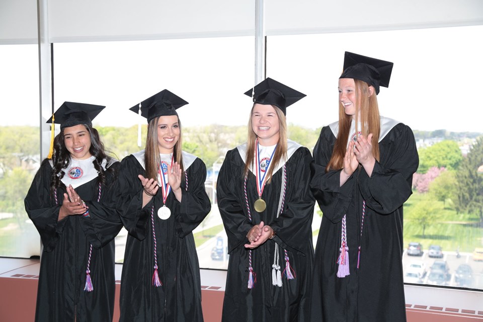 From left, Jordan Manno, Sydney Pollock, Courtney Gilbert and Ashley Mauser had a special graduation on Tuesday because they were out of state in a softball tournament during Saturday's scheduled commencement.