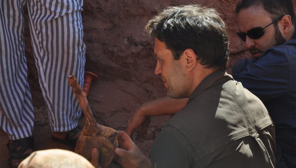Detroit Mercy's Nizar Ibrahim with one of the tail bones of Spinosaurus. Photo: Gabriele Bindellini.