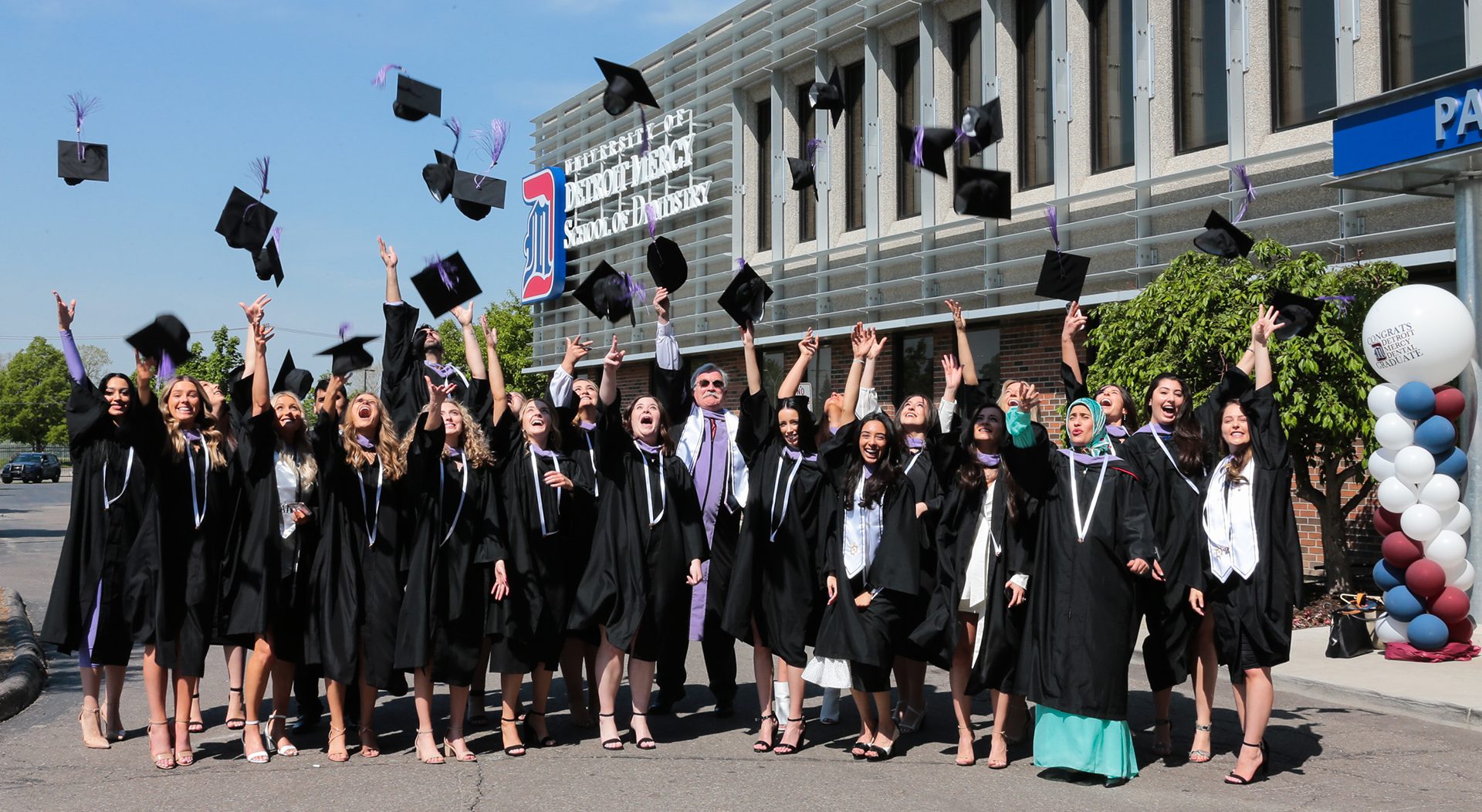 Class of 2021 students throw their caps up in the air in celebration!