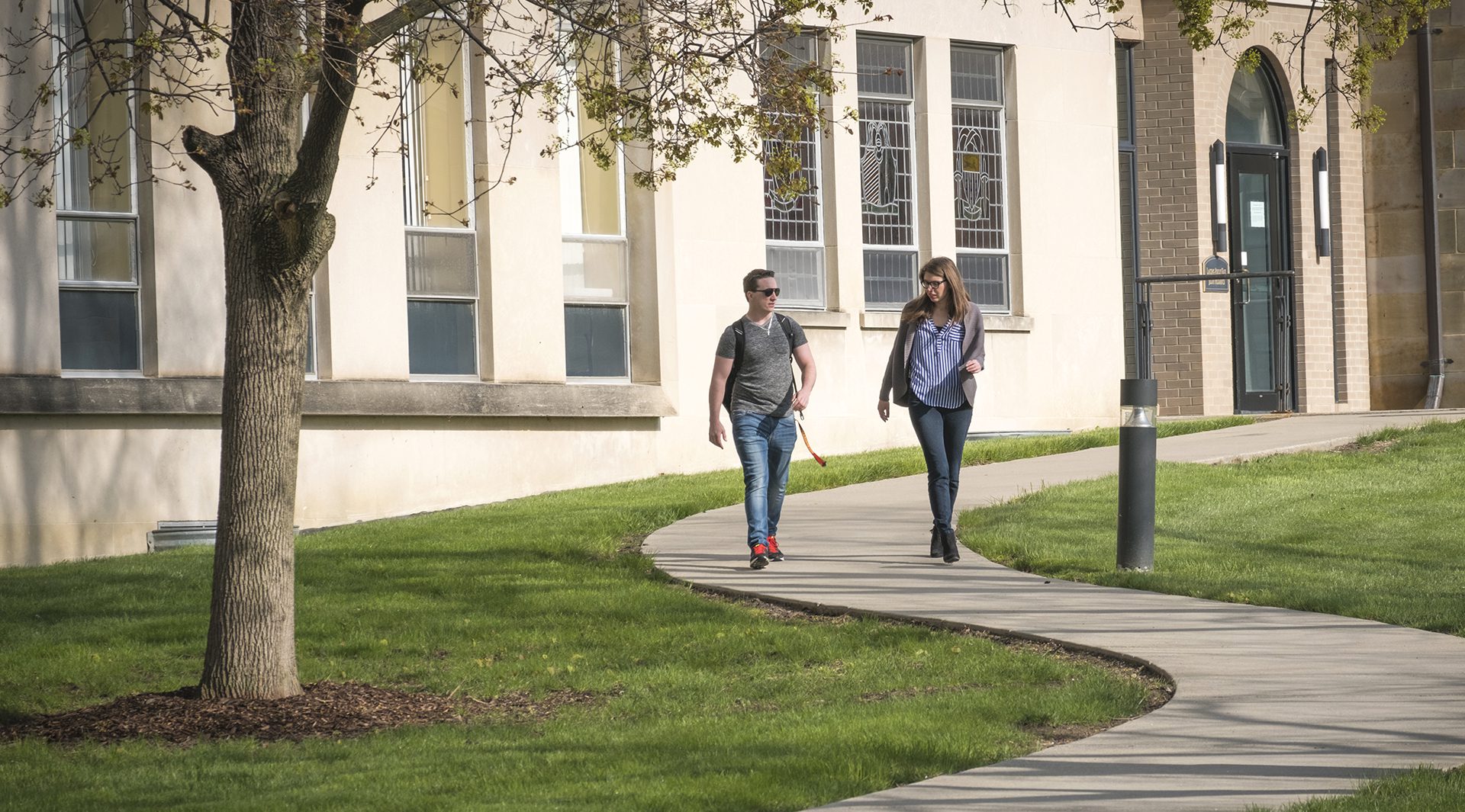 Two students walk away from Health Professions Facility.