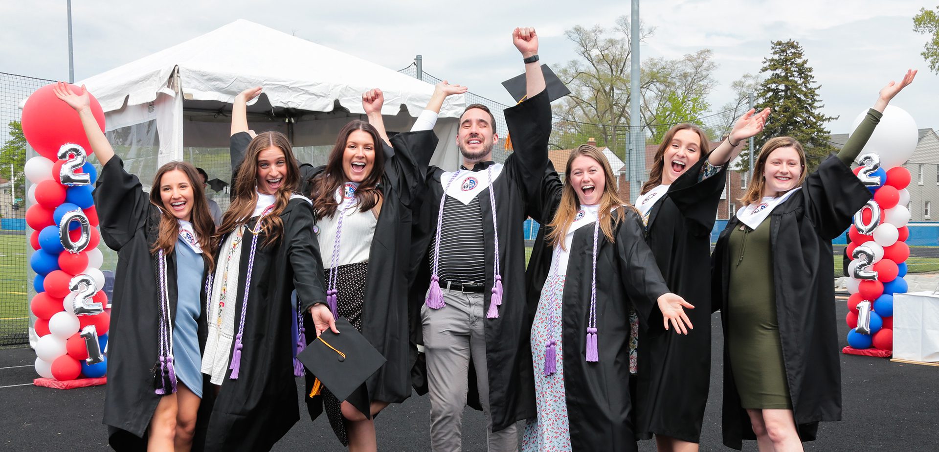 Class of 2021 students throw their hands up in excitement!