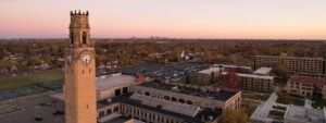 An aerial photo of the McNichols Campus, looking towards downtown Detroit with the clock tower in the foreground and other campus buildings pictured.