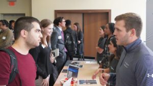 More than a dozen people talk during the 2023 Fall Career and Co-op Fair inside of the Student Union Ballroom.
