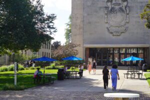 Students walk on the campus in front of the McNichols Campus Library during the first day of classes.