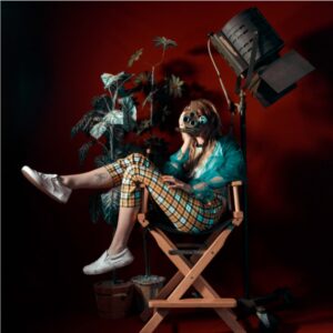 A photo of a photographer sitting in a chair. "Look Out for Millennials," by Erick Mori-Quimper FROM [SIC] ISSUE 25