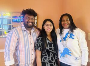 An image of three individuals standing close together, which was taken when Prof. Ashlee Barnes hosted two Indian students for Thanksgiving 2024.