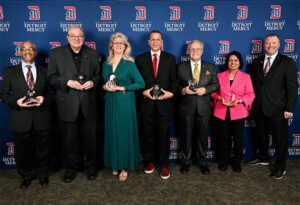 An image of 7 people holding Spirit Awards in their hands.