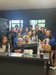 An image of several students standing behind a desk in the Student Success Center at UDM.