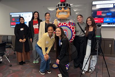 Courtney Christian and her classmates pose for a photo with Tommy Titan.
