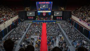 Overhead photo inside of Calihan Hall of 2025 Commencement, featuring hundreds of people sitting.