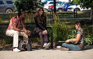 Students sit near the fountain on the McNichols Campus.