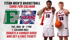 A graphic for Titan Men’s Basketball “Cans for Calihan” event. The image features two basketball players in Detroit Mercy uniforms, one holding a basketball and the other holding a net over the shoulder. Large text at the top reads: “Titan Men’s Basketball Cans for Calihan.” Logos for Eastern Michigan and Detroit Mercy are displayed with “vs” between them. Event details: “Tue, Nov. 18 at 7 p.m. at Calihan Hall.” A red banner at the bottom says: “Donate a canned good and get a free ticket!”