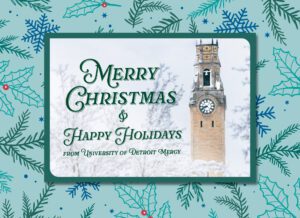 UDM Christmas card front. Text reads "Merry Christmas & Happy Holidays from University of Detroit Mercy" atop a wintery scene and UDM clocktower.