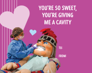 A purple Valentine's Day card featuring Tommy Titan and a student working on him at the Dental school. Words read, 'YOU'RE SO SWEET, YOU'RE GIVING ME A CAVITY.'