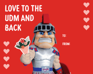 A red Tommy Titan Valentine's Day card featuring hearts and the words, 'LOVE TO THE UDM AND BACK.'