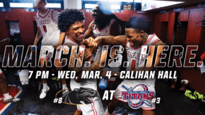 A graphic with four players celebrating inside of the Calihan Hall locker room. Text reads, 'MARCH. IS. HERE. 7 p.m., Wednesday, March 4, Calihan Hall, No. 8 Milwaukee at No. 3 Detroit Mercy.'