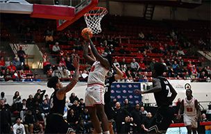 A Titans men's basketball player drives to the basket during the game against Milwaukee.