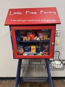 An image of a red box with food items inside it titled Little Free Pantry.