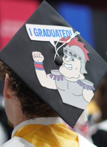 A graduation cap decorated with a cartoon Tommy Titan saying "I graduated"