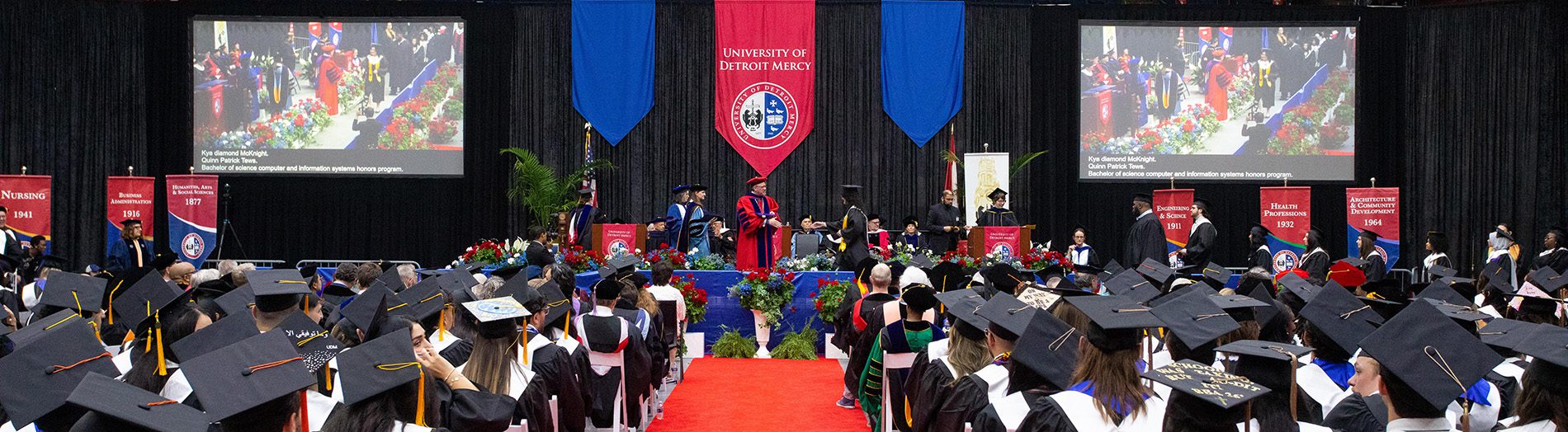 Graduates walk across the stage during UDM's Commencement ceremonies.