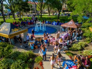An aerial photo of Titan Fest 2026 on the McNichols Campus featuring hundreds of people below near the Fisher Fountain.