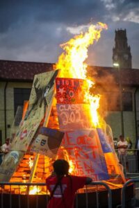bonfire burning with student org posters