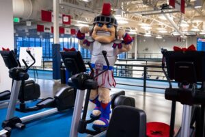 Tommy Titan with arms flexed on a new treadmill