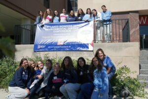 Students centered around Bioneers sign