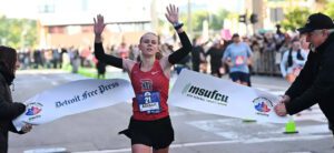 Allison Sherman crosses the finish line at the 2026 Detroit Free Press Marathon.