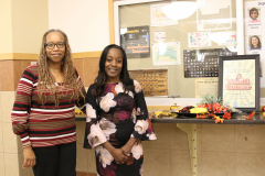 Lezly Pruitt and Delanda Dixon get ready for the community receiption.