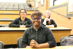 Three Detroit Mercy students wait for the presentation to begin.